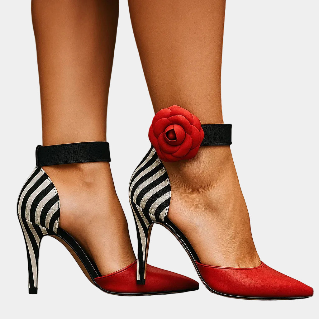 Red pointed-toe high-heel pumps with black ankle strap and red rose detail
