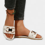 White comfort slide sandals with round toe, wide buckle straps and gold hardware