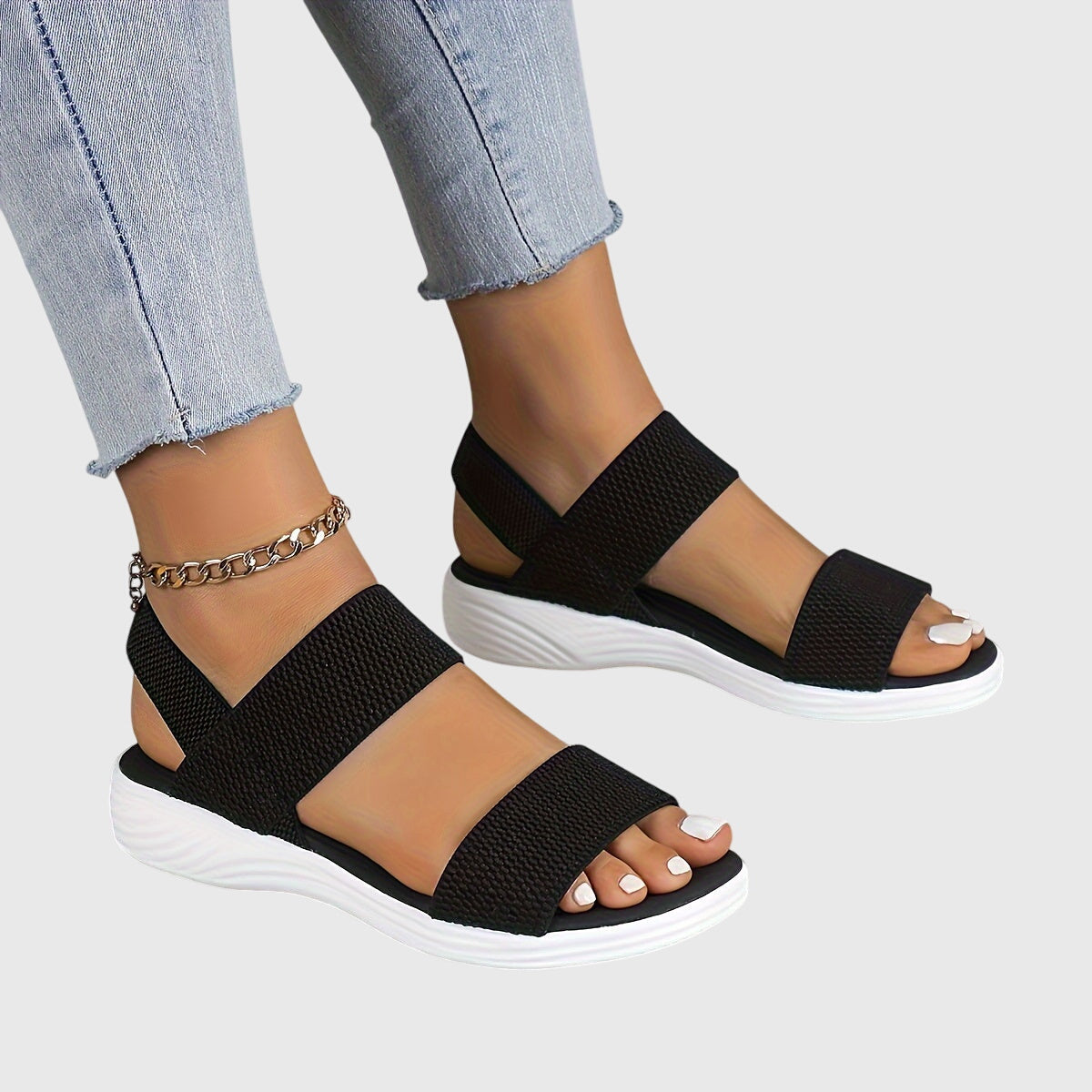 Black orthopedic sandals with two wide straps, open toe, cushioned white sole