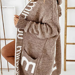 Beige-brown hooded knit cardigan with white geometric bands, long sleeves, front pockets