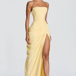 Pale yellow strapless corset maxi dress with draped skirt and high front slit