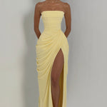 Pale yellow strapless corset maxi dress with draped overlay and high front slit