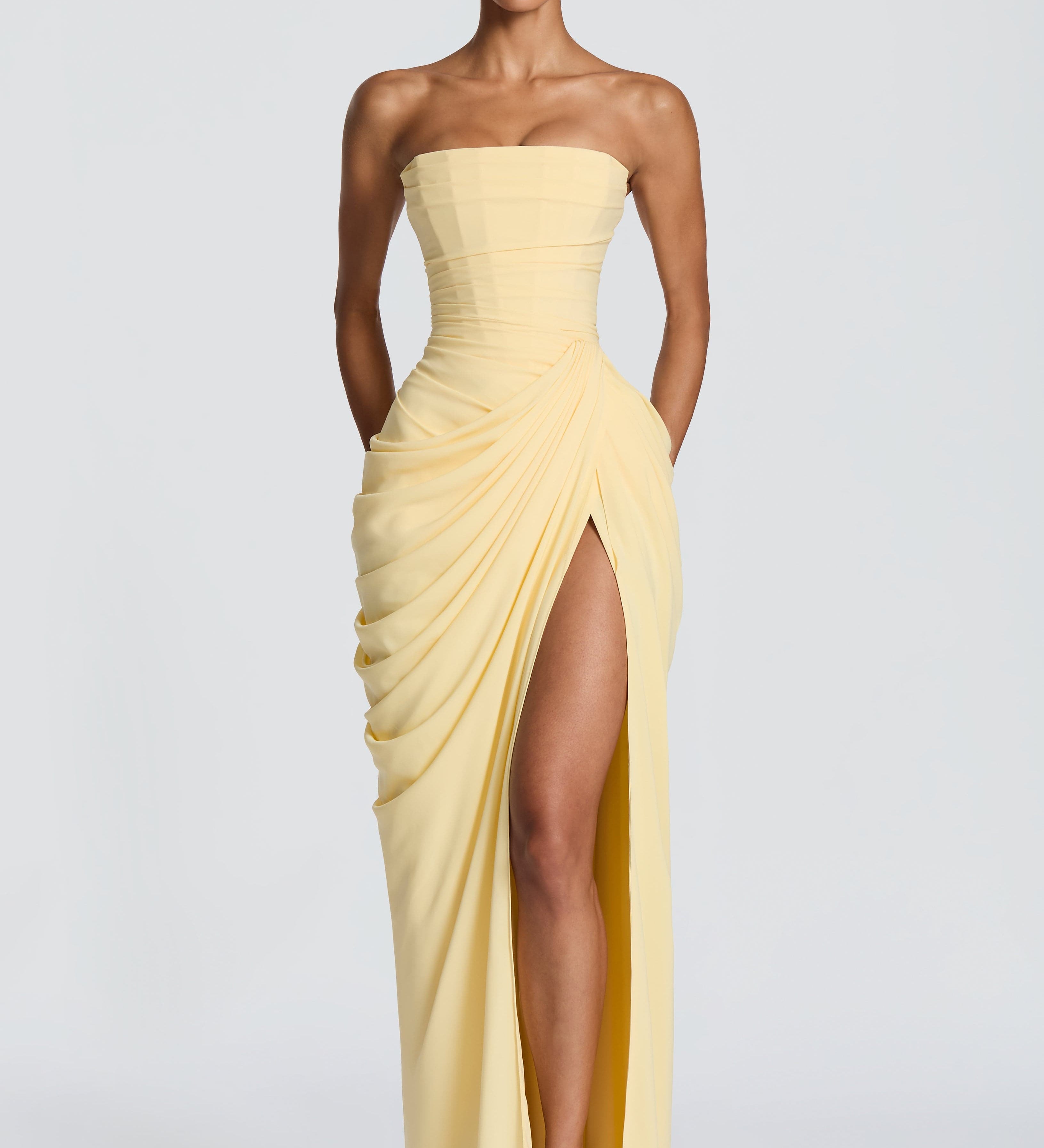 Strapless pale yellow corset maxi dress with draped front and high thigh slit