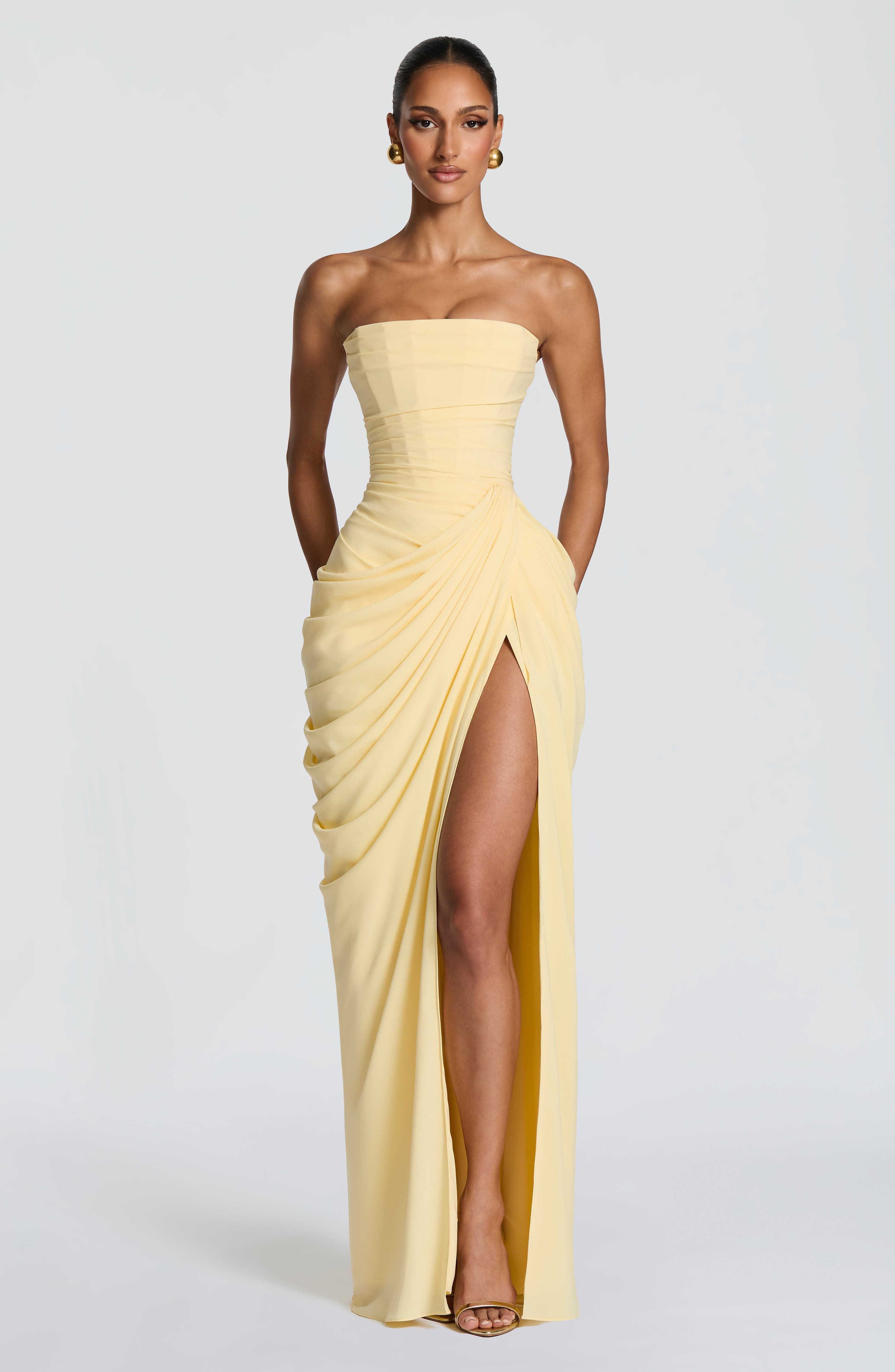 Strapless pale yellow corset maxi dress with draped front and high thigh slit