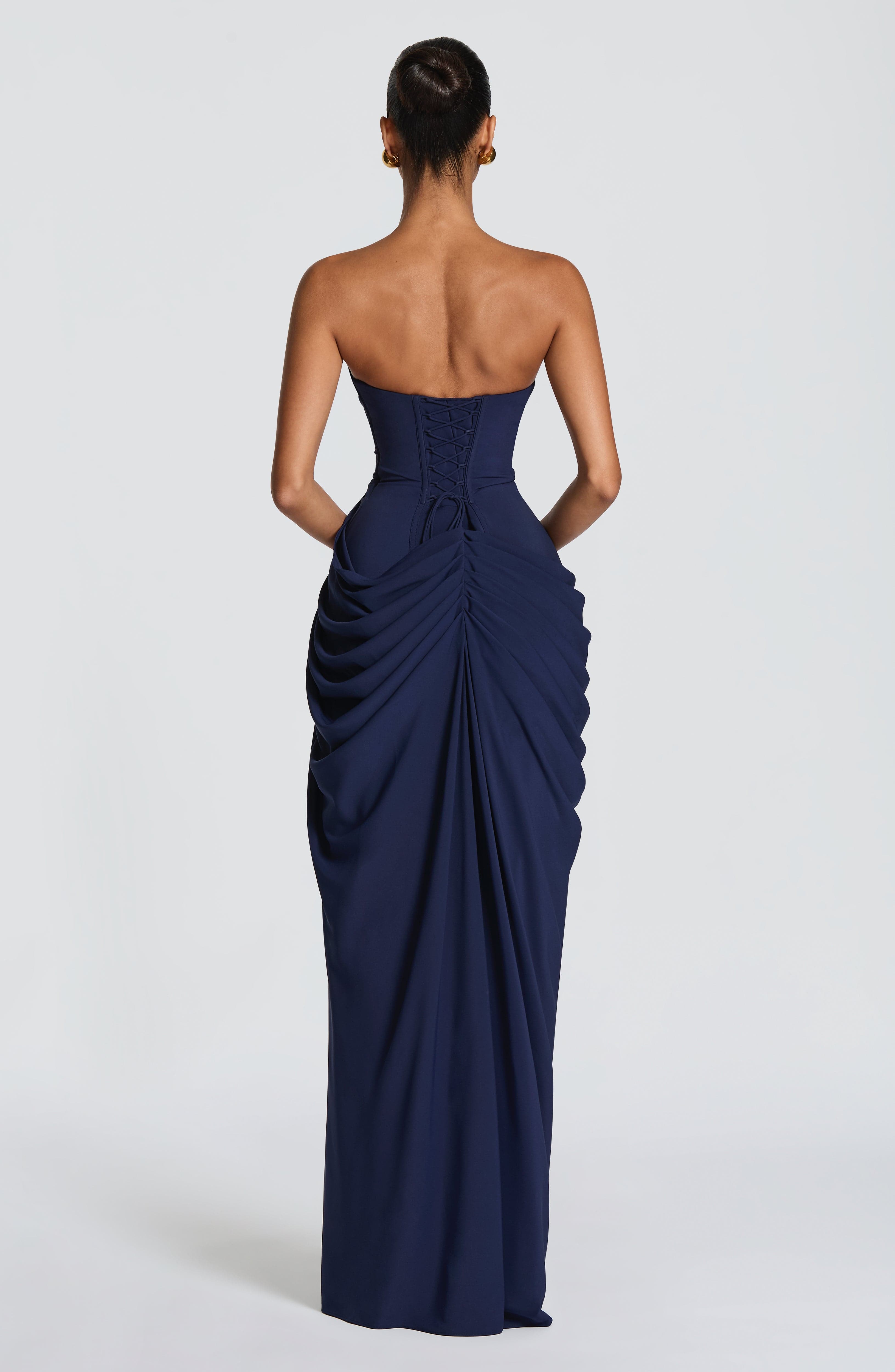 Back view of navy strapless corset maxi dress with gathered draped details