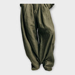 Dark olive green gathered high-waist balloon pants with front pleats and elastic hem
