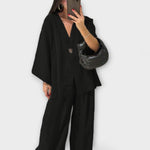 Black layered V-neck top and wide-leg pants set with button front