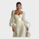 Light cream romantic maxi dress with off-shoulder neckline, gathered skirt, billowy sleeves