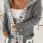 Light gray open-front knit cardigan with white geometric trim, long sleeves, front pockets
