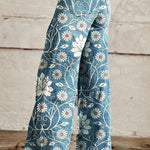 Wide-leg boho trousers with blue fabric and white daisy floral vine pattern