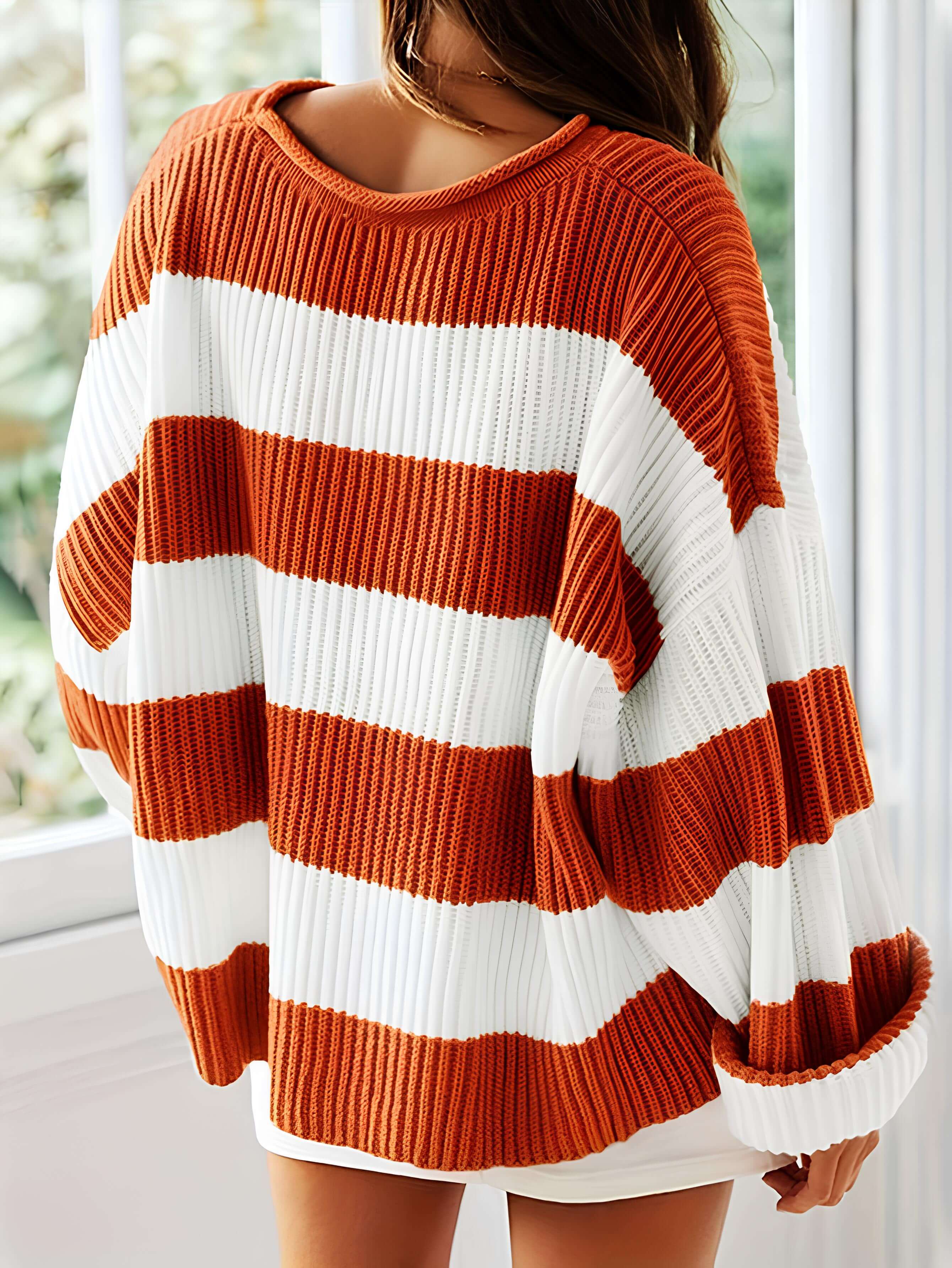 Women's winter sweater with orange and white horizontal stripes, ribbed knit crewneck
