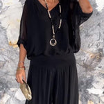 Two-piece chiffon set with V-neck blouse and tiered wide-leg pants, black.