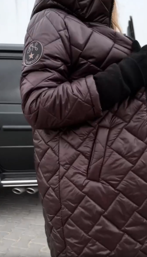 Hooded puffer coat sleeve, dark plum, circular patch on upper arm