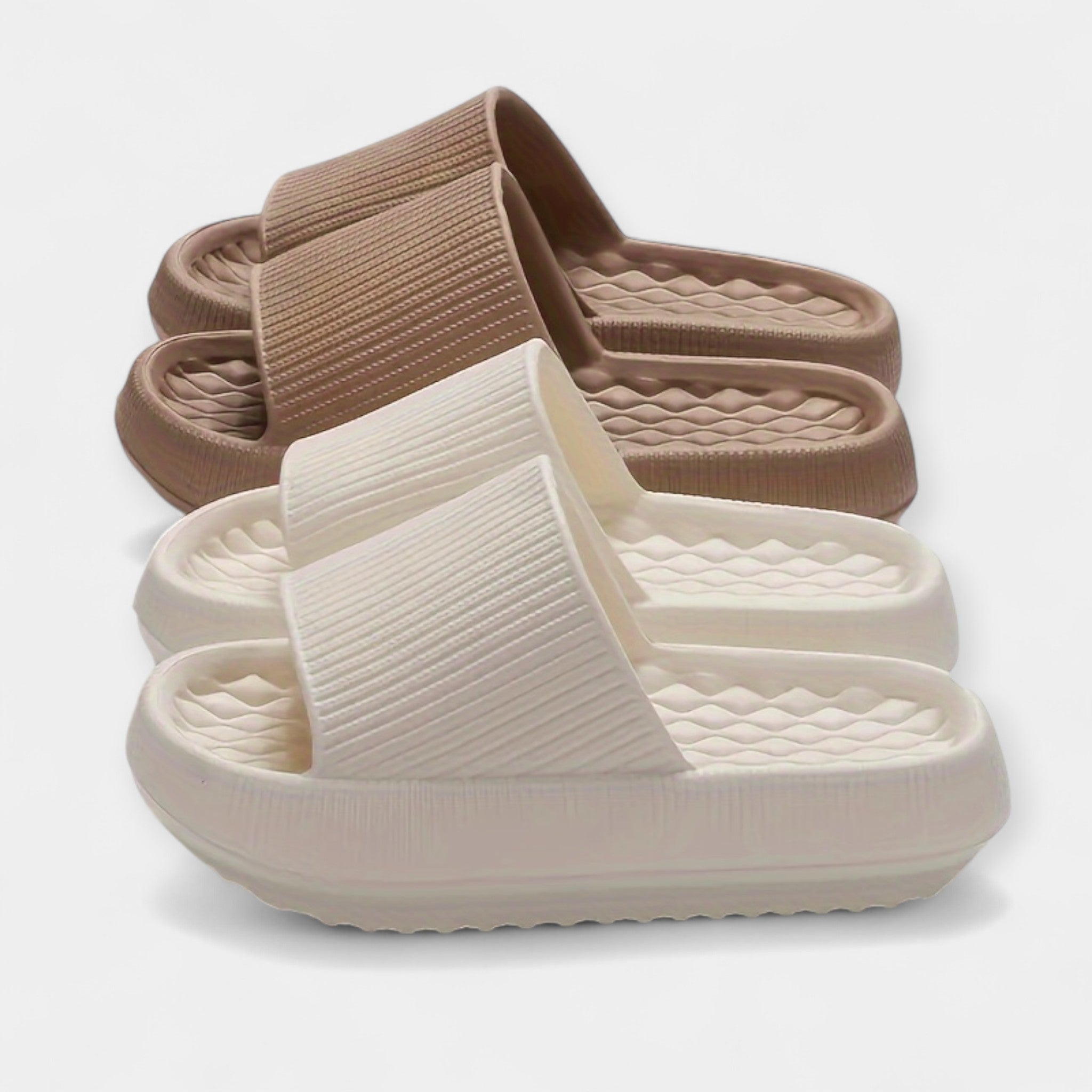 Tan and white textured slide sandals with wide strap and thick cushioned sole
