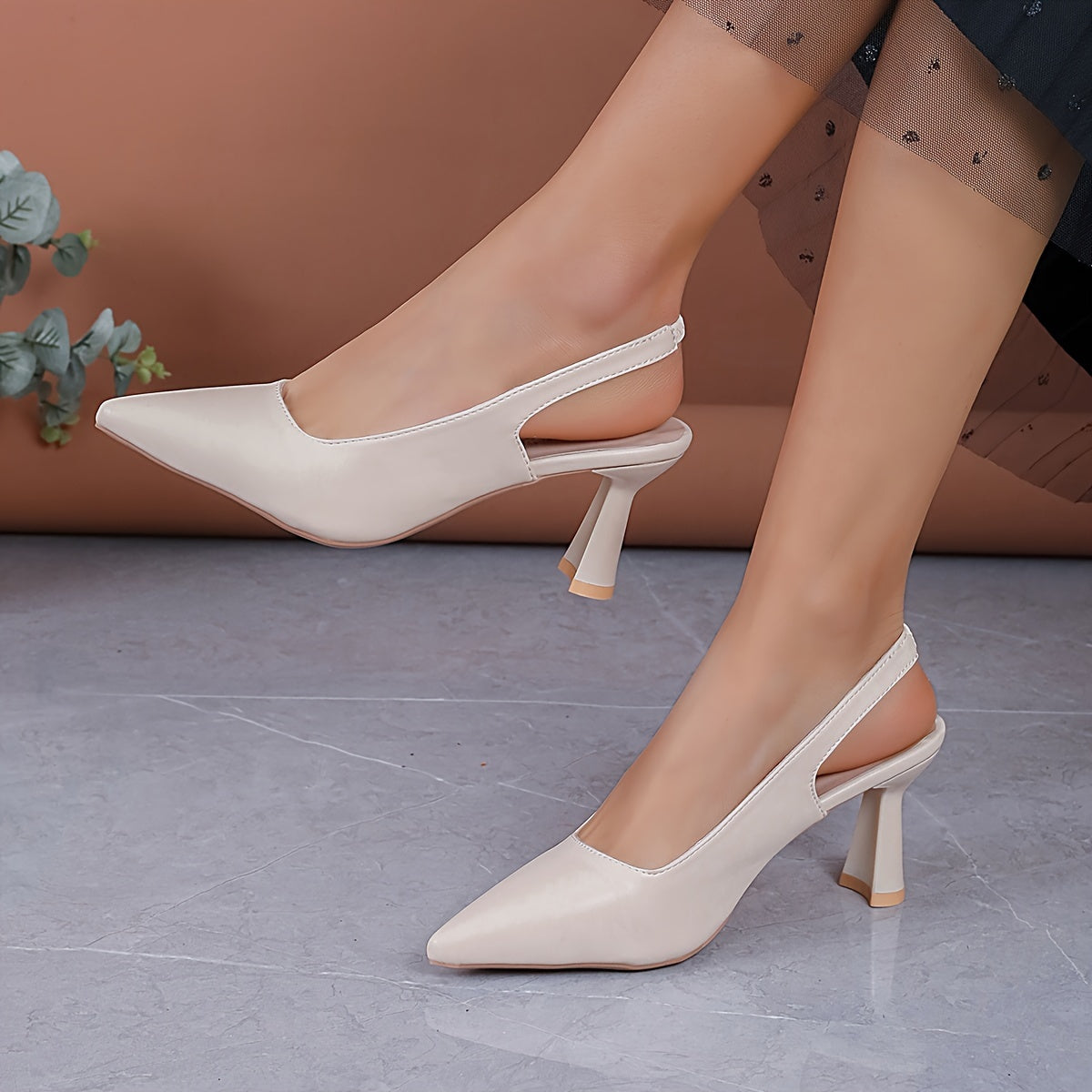White slingback pumps with pointed toe and mid block heel