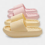 Summer slip-on sandals with thick sole, ribbed straps in pink and pale yellow.