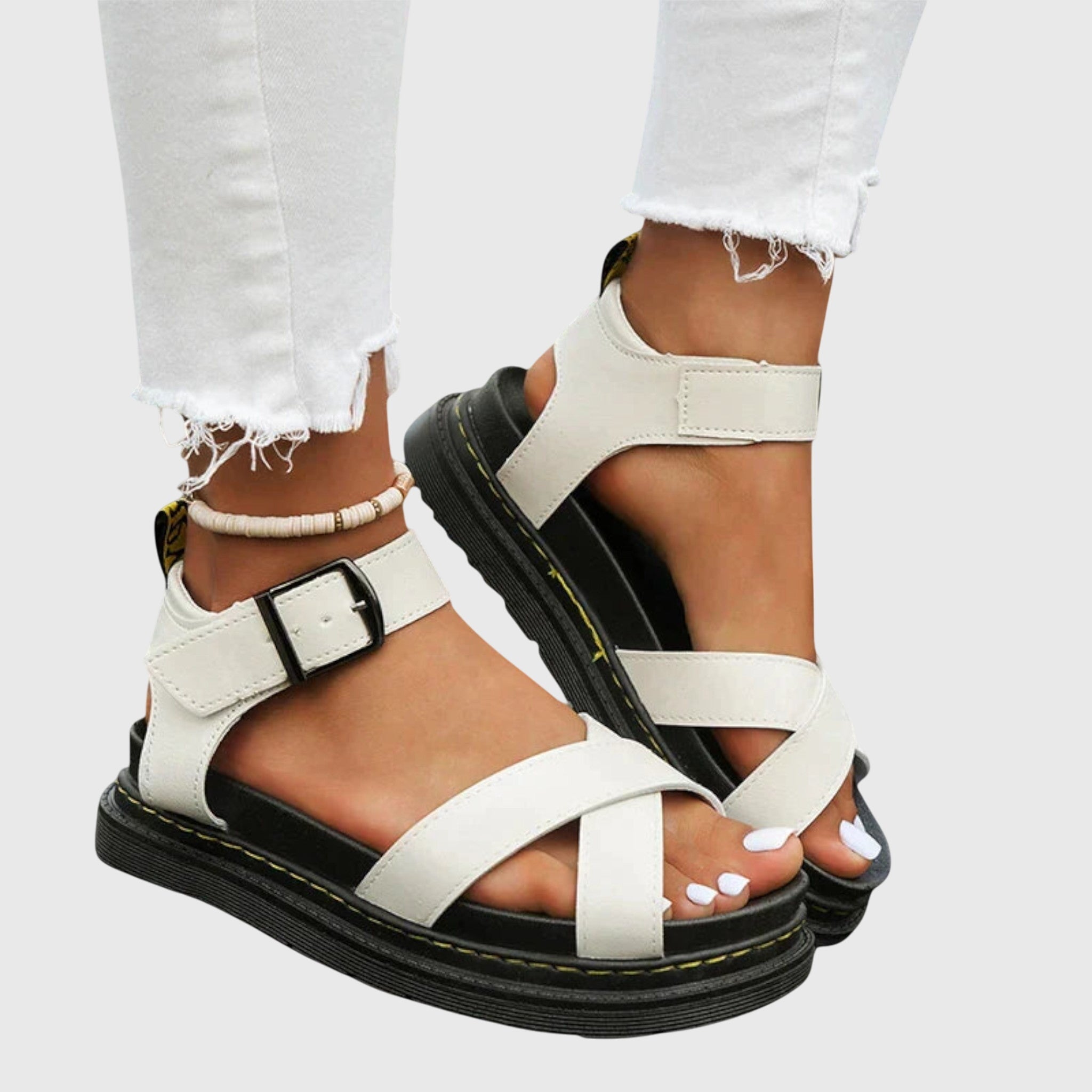 White comfort sandals with two straps and buckle, chunky sole with yellow stitching