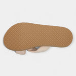 Wide bow sandals outsole view with textured tan sole and visible cream upper edge
