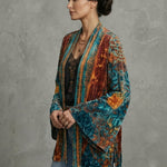 Boho artistic jacket, side view with teal and rust multicolor pattern and loose sleeve cuffs