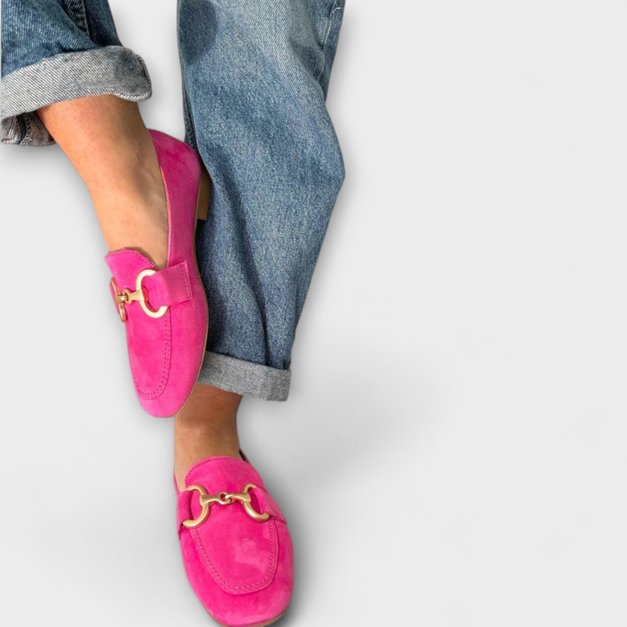 Women’s pink moccasin loafers with gold chain-style buckle, rounded toe