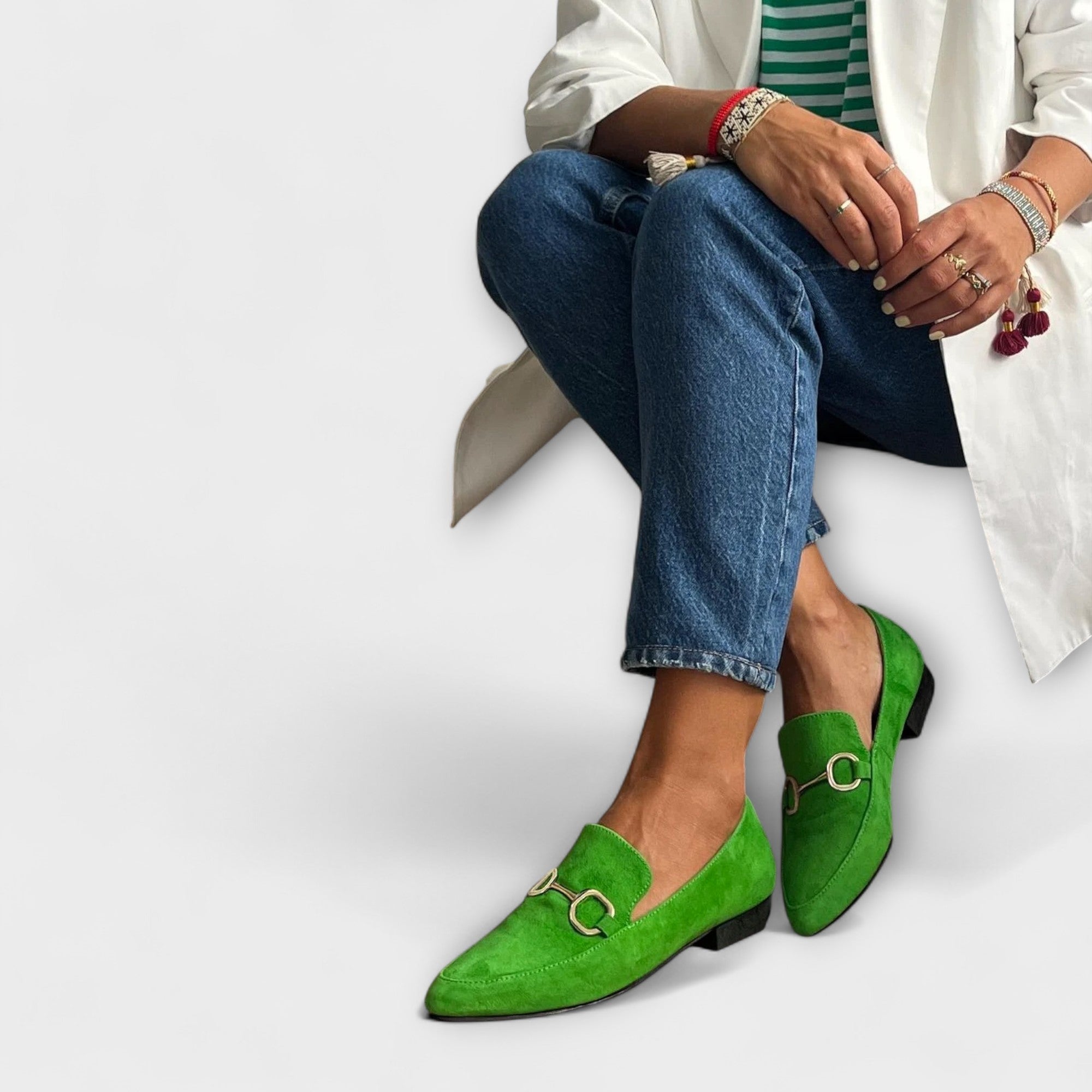 Green slip-on loafers with buckle detail and low heel