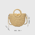 Beige round-woven straw shoulder bag with ring handles and crossbody strap.