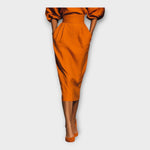 Orange midi dress side view with puff sleeves and fitted pencil skirt
