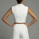 White sleeveless short dress from back view with belted waist and tailored shorts