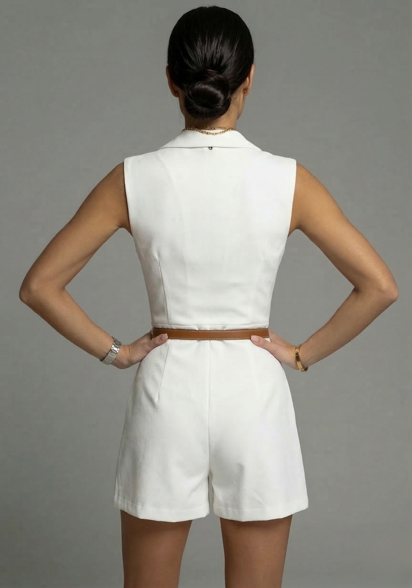 White sleeveless short dress from back view with belted waist and tailored shorts
