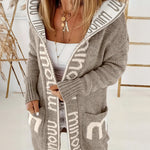 Light gray knit cardigan with white geometric trim, open front, long sleeves, pockets