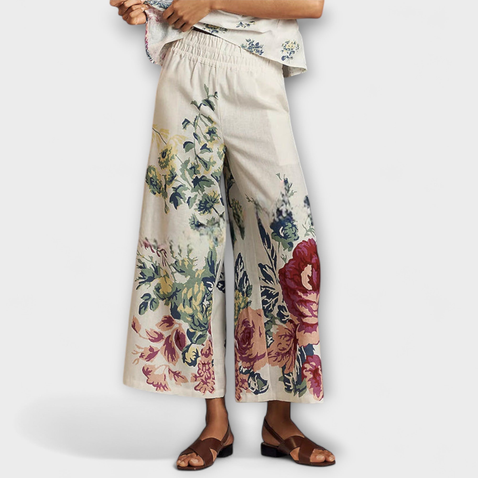 Wide-leg floral trousers with elastic waist, cream background and burgundy, blue, and green prints