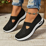 Black orthopedic knit slip-on sneakers with side cutout panels and white rubber sole