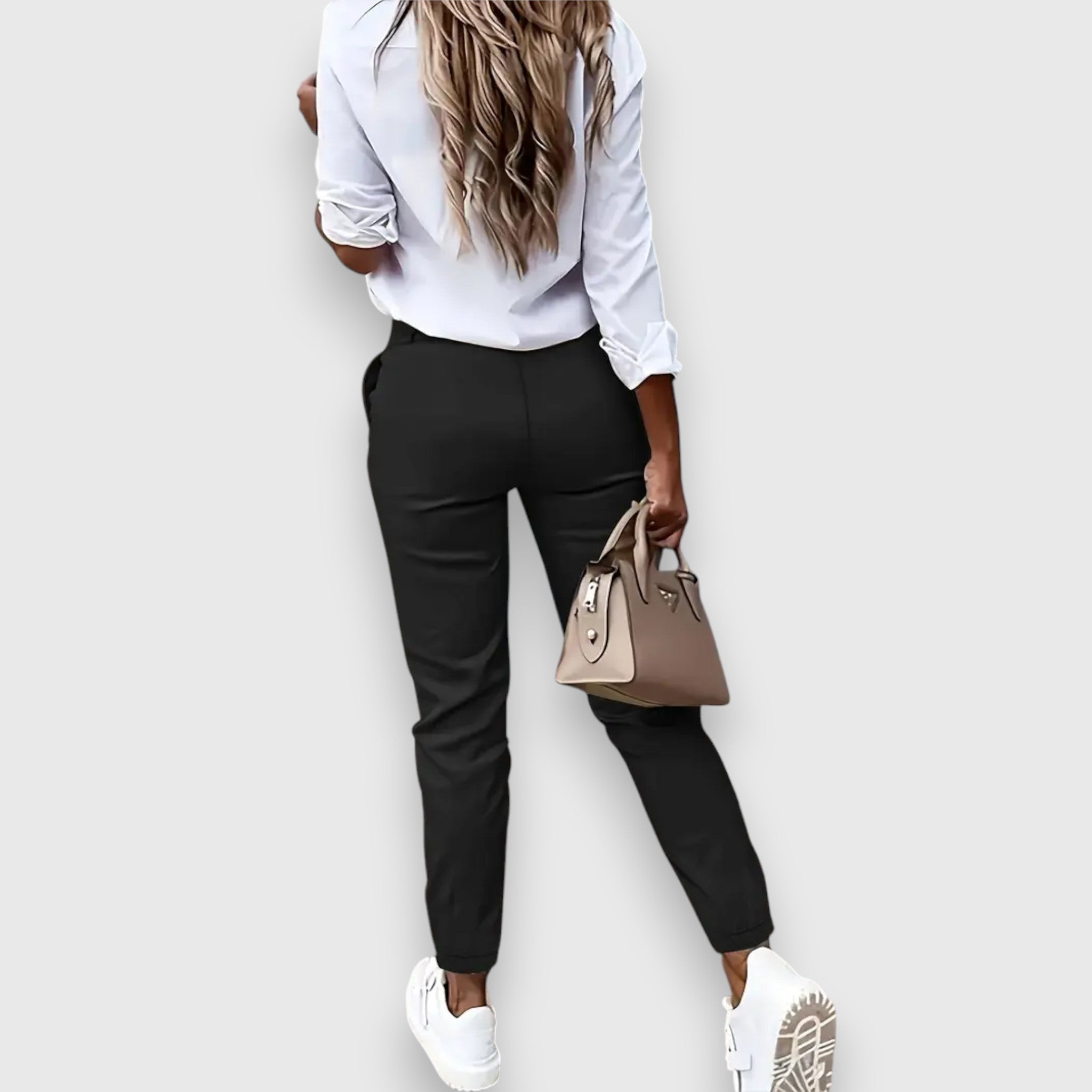High-waisted black dress pants with belt loops and tapered legs, side view