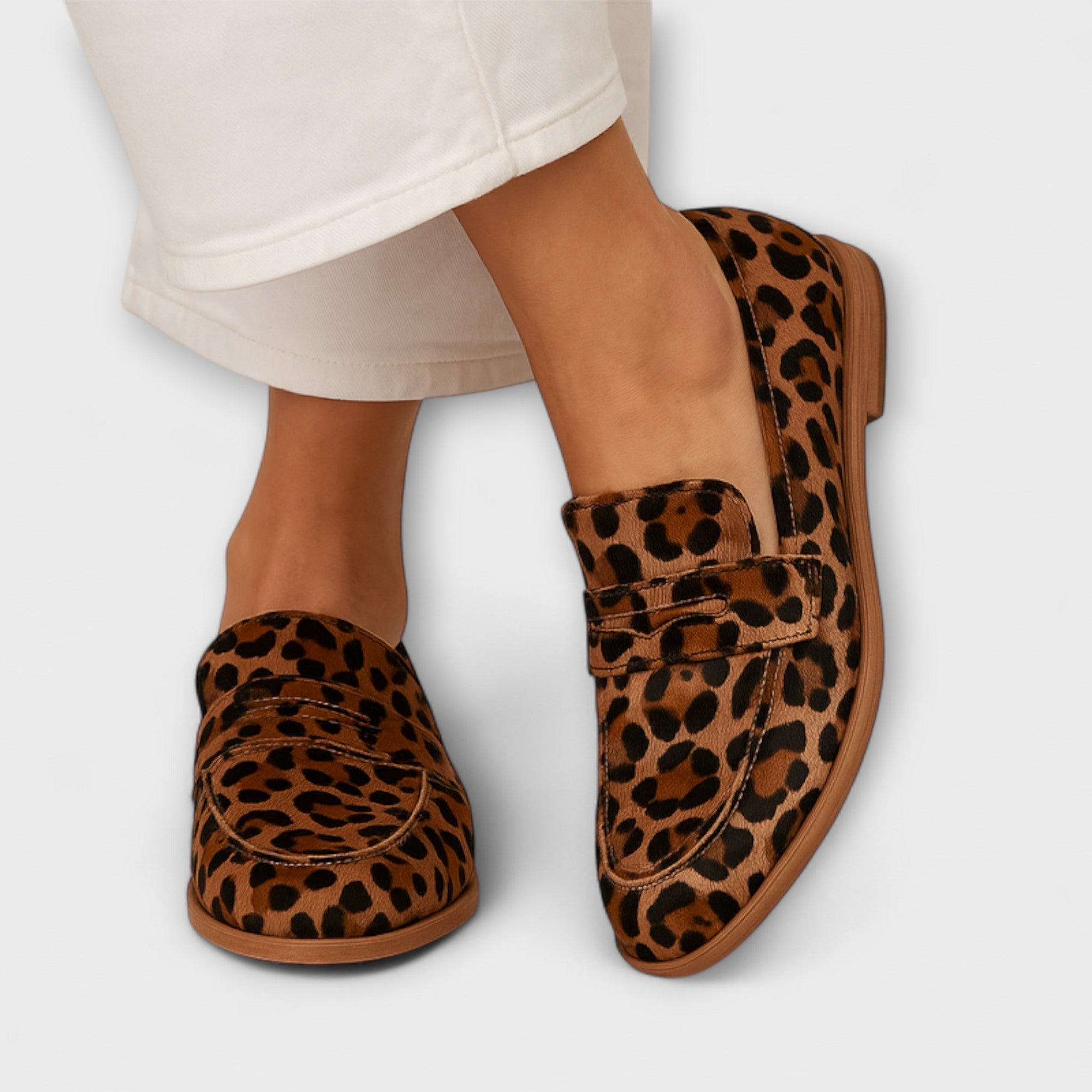 Leopard-print slip-on moccasins with strap detail and flat brown sole