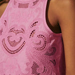 Pink lace sleeveless crop top with embroidered motifs and scalloped edge