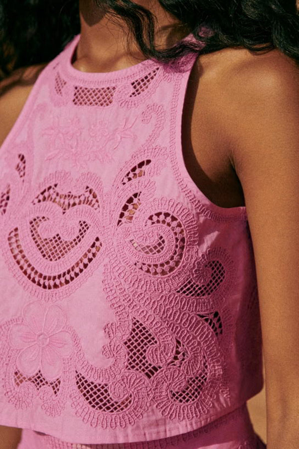 Pink lace sleeveless crop top with embroidered motifs and scalloped edge