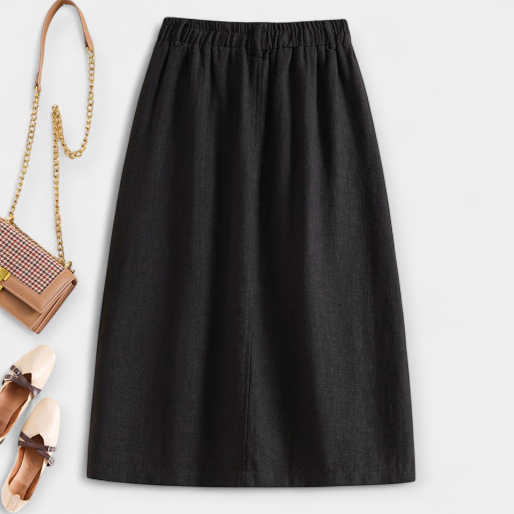Black midi skirt with elastic waistband and side pockets; front button placket.