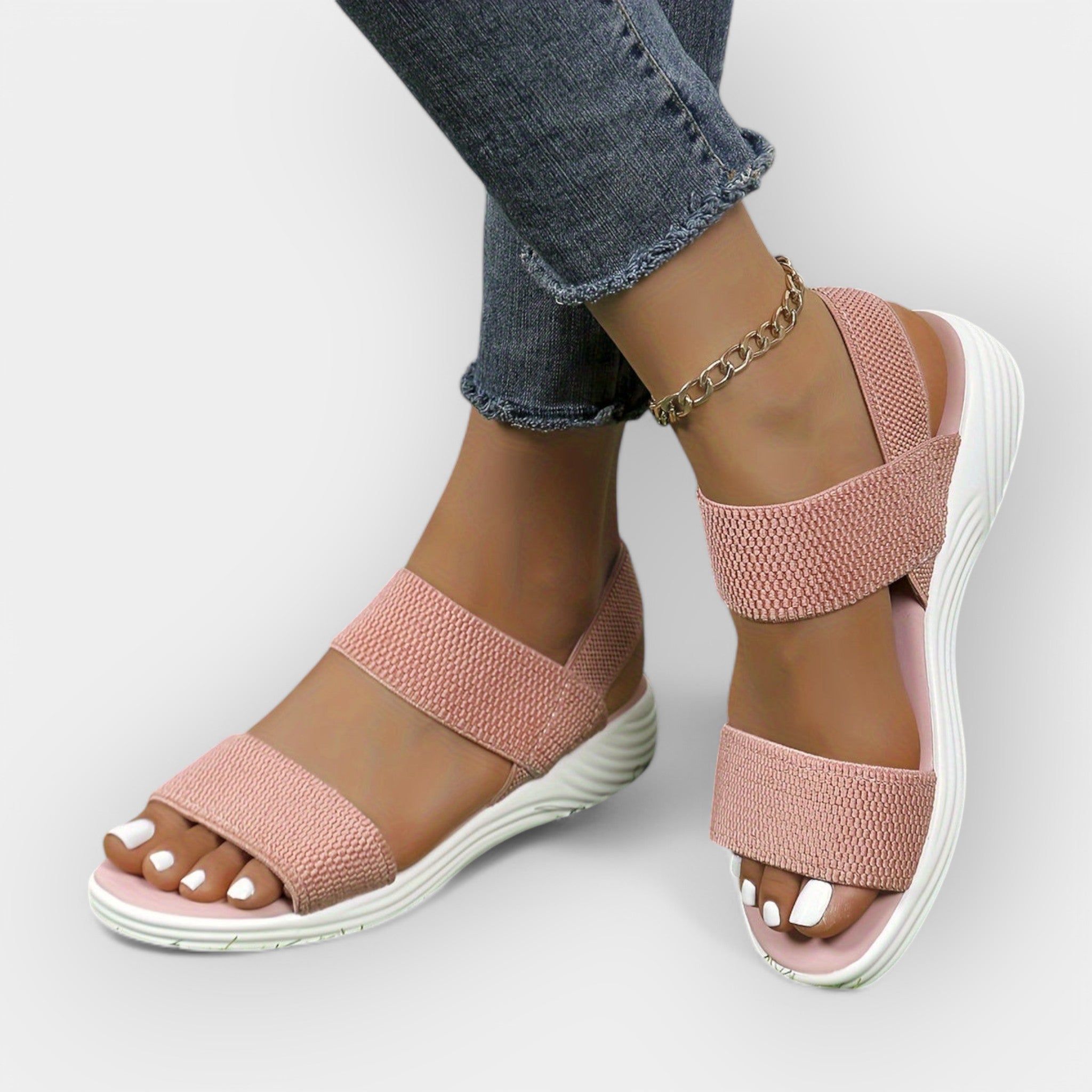 Comfort sandals with wide textured straps, open toe, blush pink upper, white platform sole.