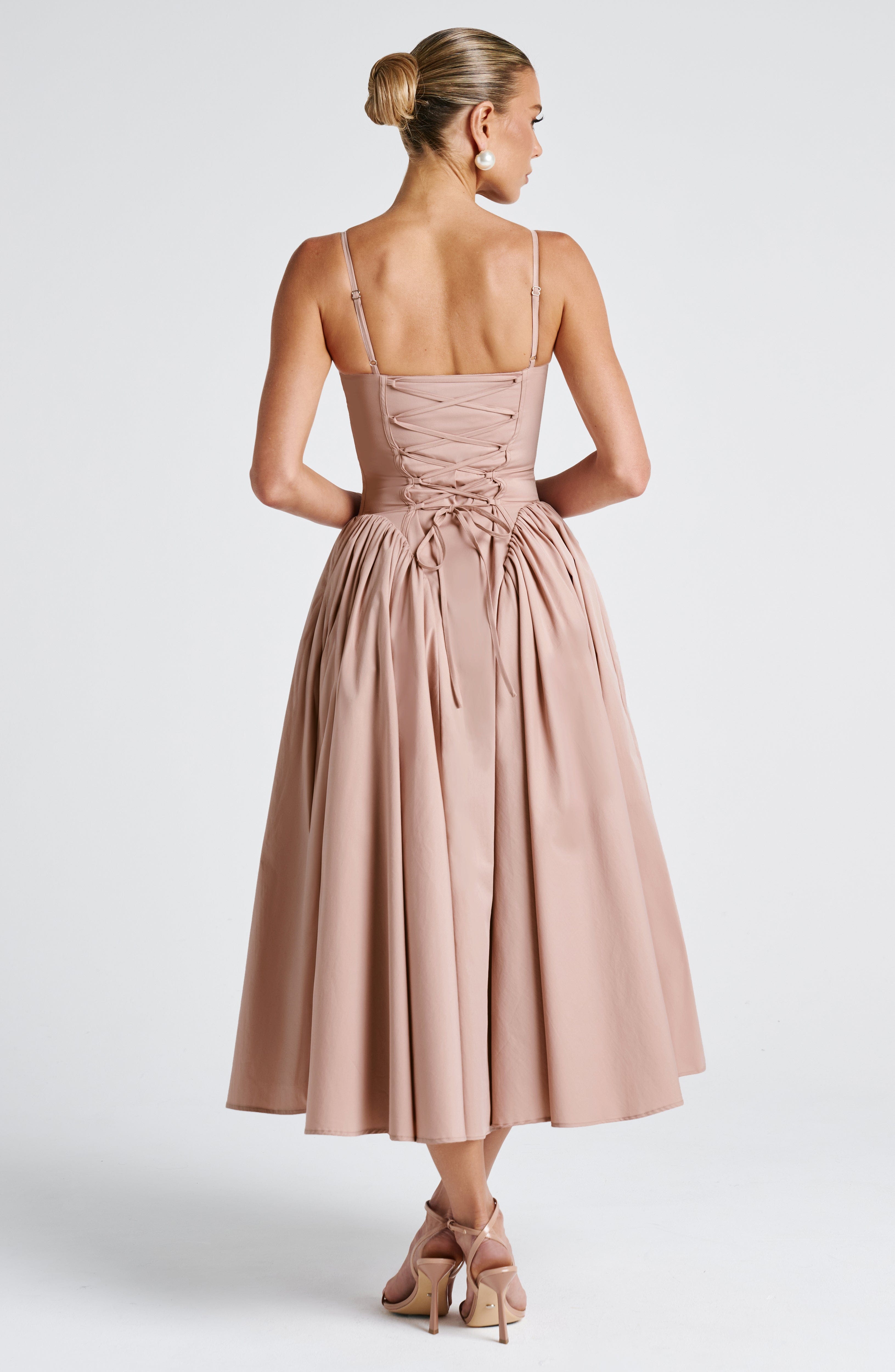 Women’s blush midi dress with thin straps and full gathered skirt, back view