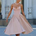 Women’s blush midi dress with thin straps and full flared skirt, walking view