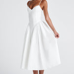 Women’s white midi dress with thin straps, fitted waist, and full flared skirt