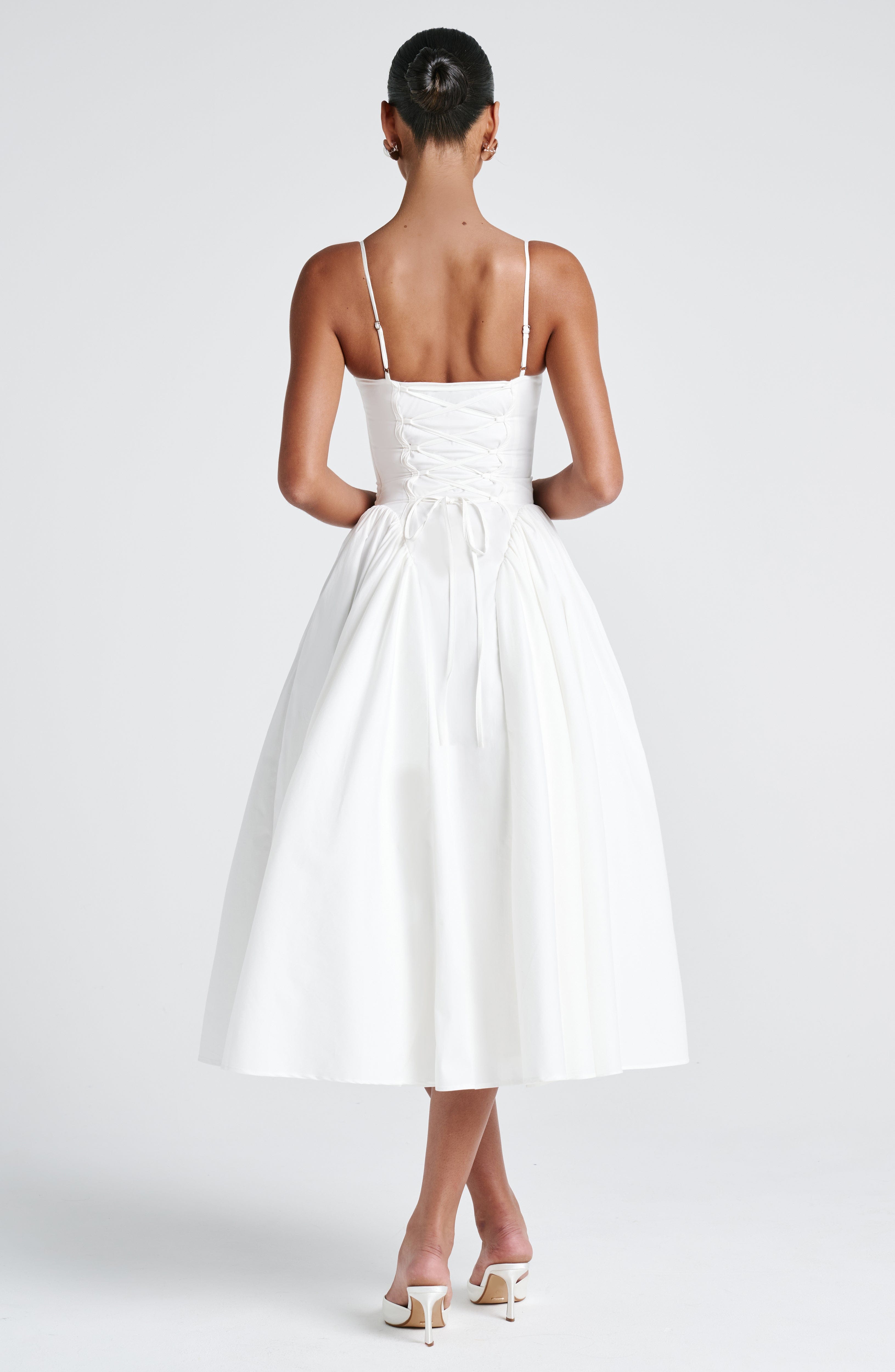 Women’s white midi dress with thin straps and full gathered skirt, back view
