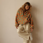 Green fuzzy fleece half-zip hoodie with orange flower print and loose long sleeves