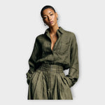 Dark olive green button-up shirt with chest pocket and gathered high-waist pants