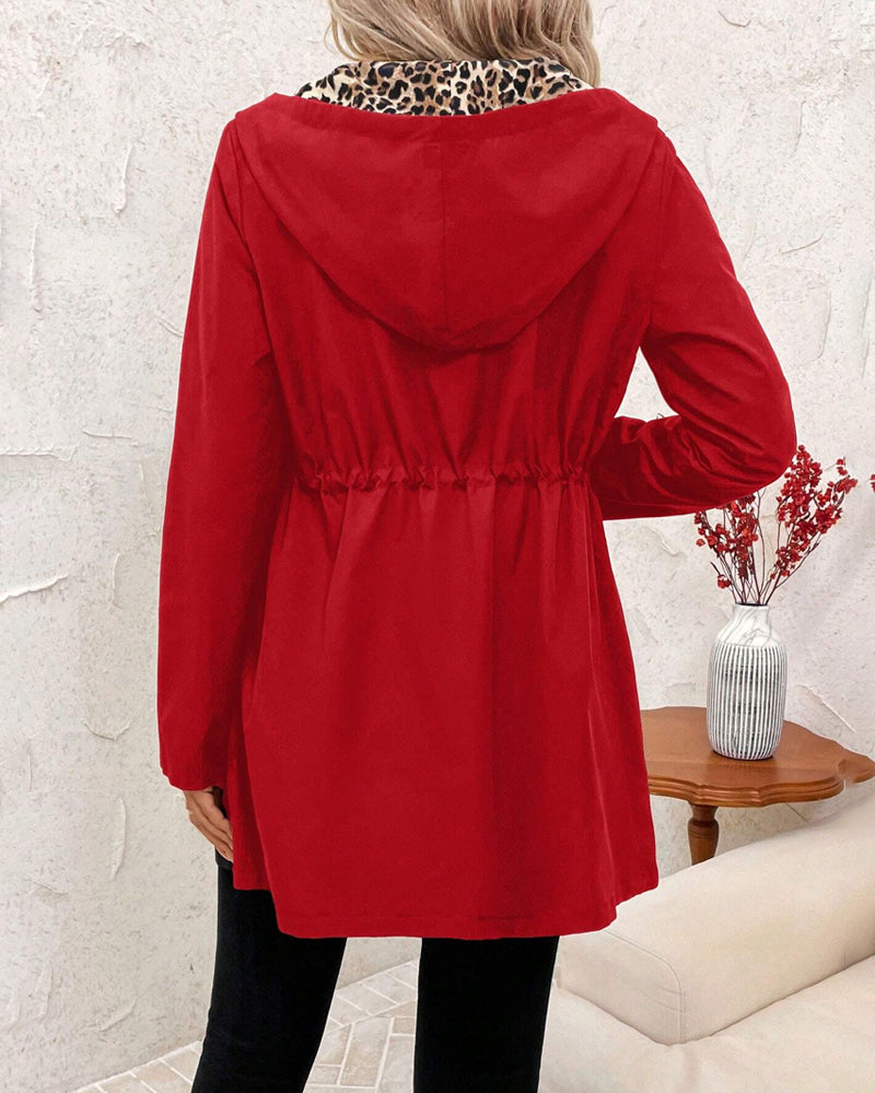 Red reversible hooded jacket with gathered waist, full sleeves, and front zipper
