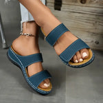 Blue orthopedic slide sandals with perforated straps and padded footbed