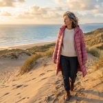 Lightweight quilted hooded jacket in pink worn over a knit top and dark pants