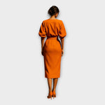 Orange midi dress back view with gathered puff sleeves and waist belt