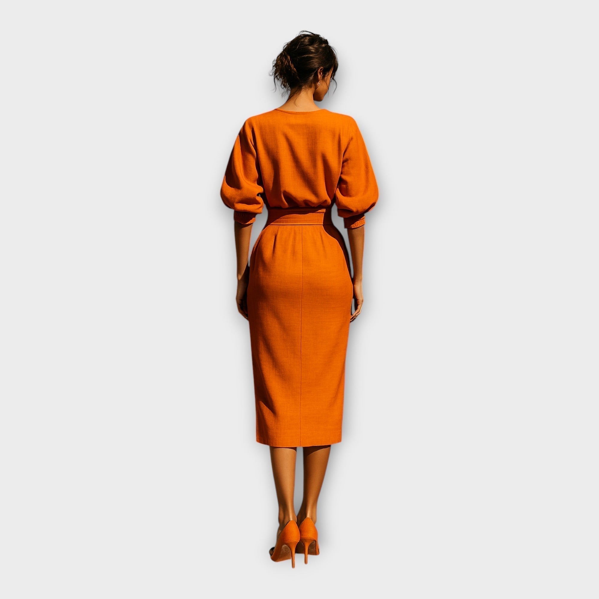 Orange midi dress back view with gathered puff sleeves and waist belt