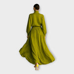 Green knit turtleneck sweater and flowing maxi skirt set, back view